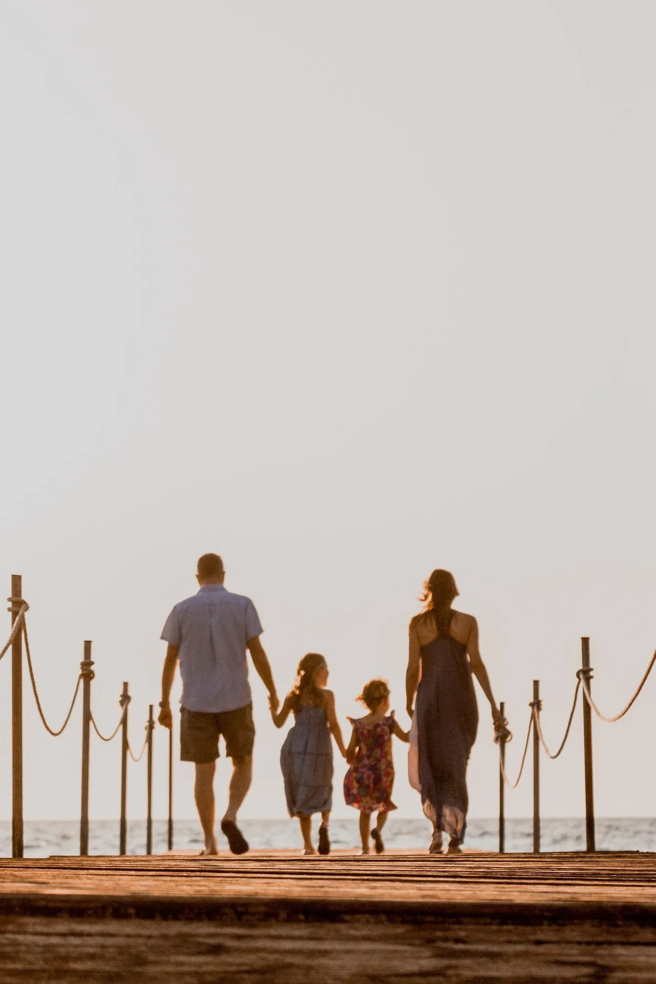 A family walking down a pier