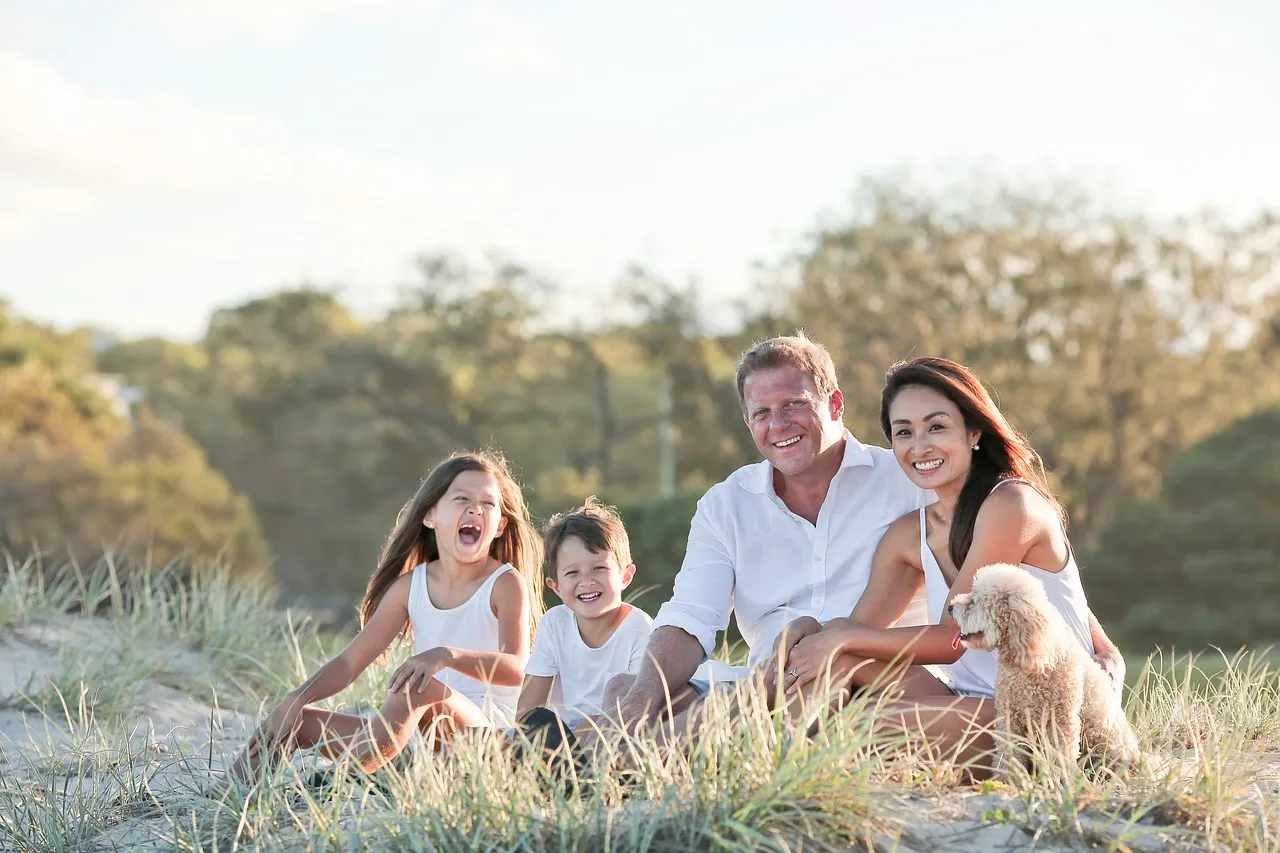A happy family in the park sitting down