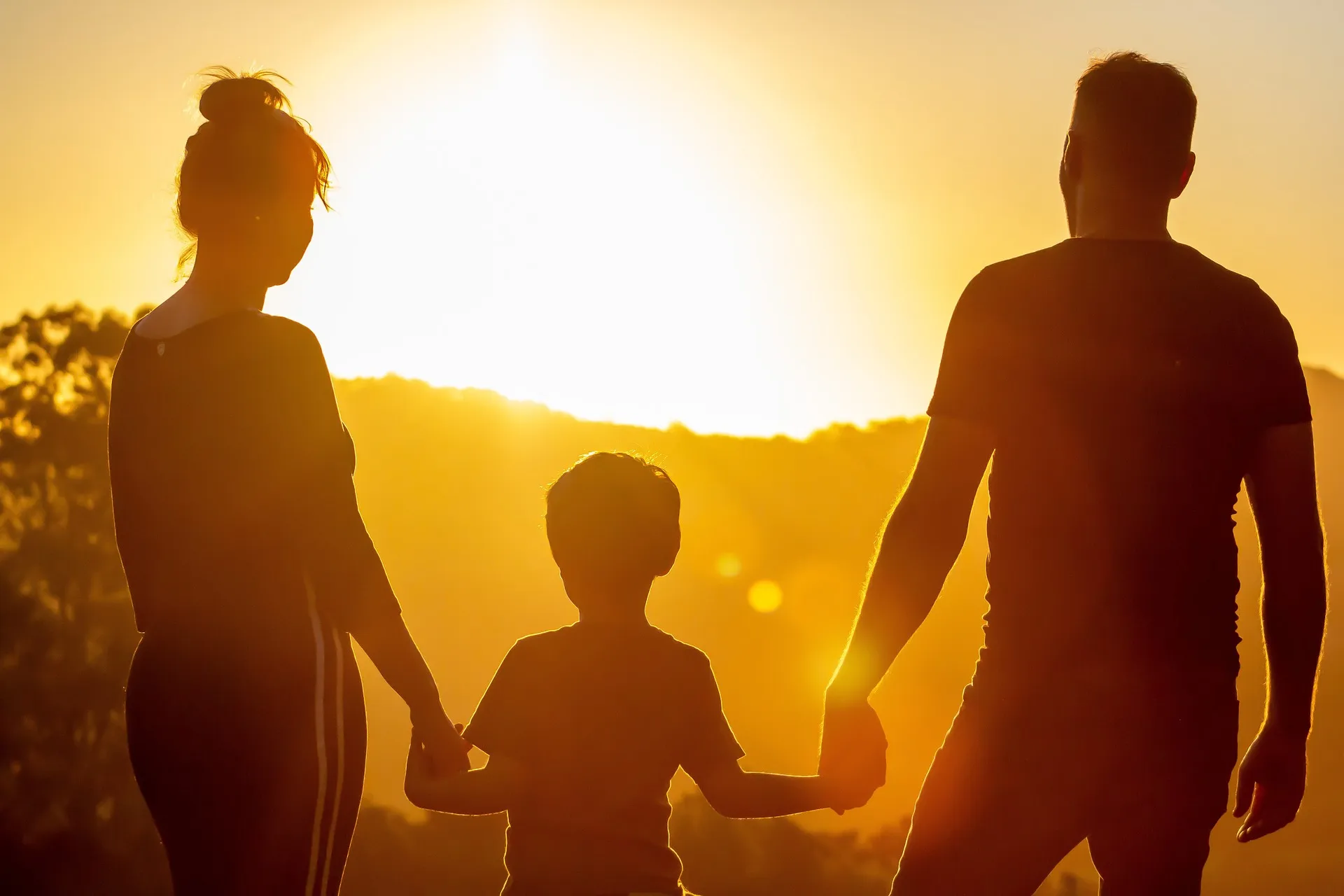 happy family looking towards a sunset view