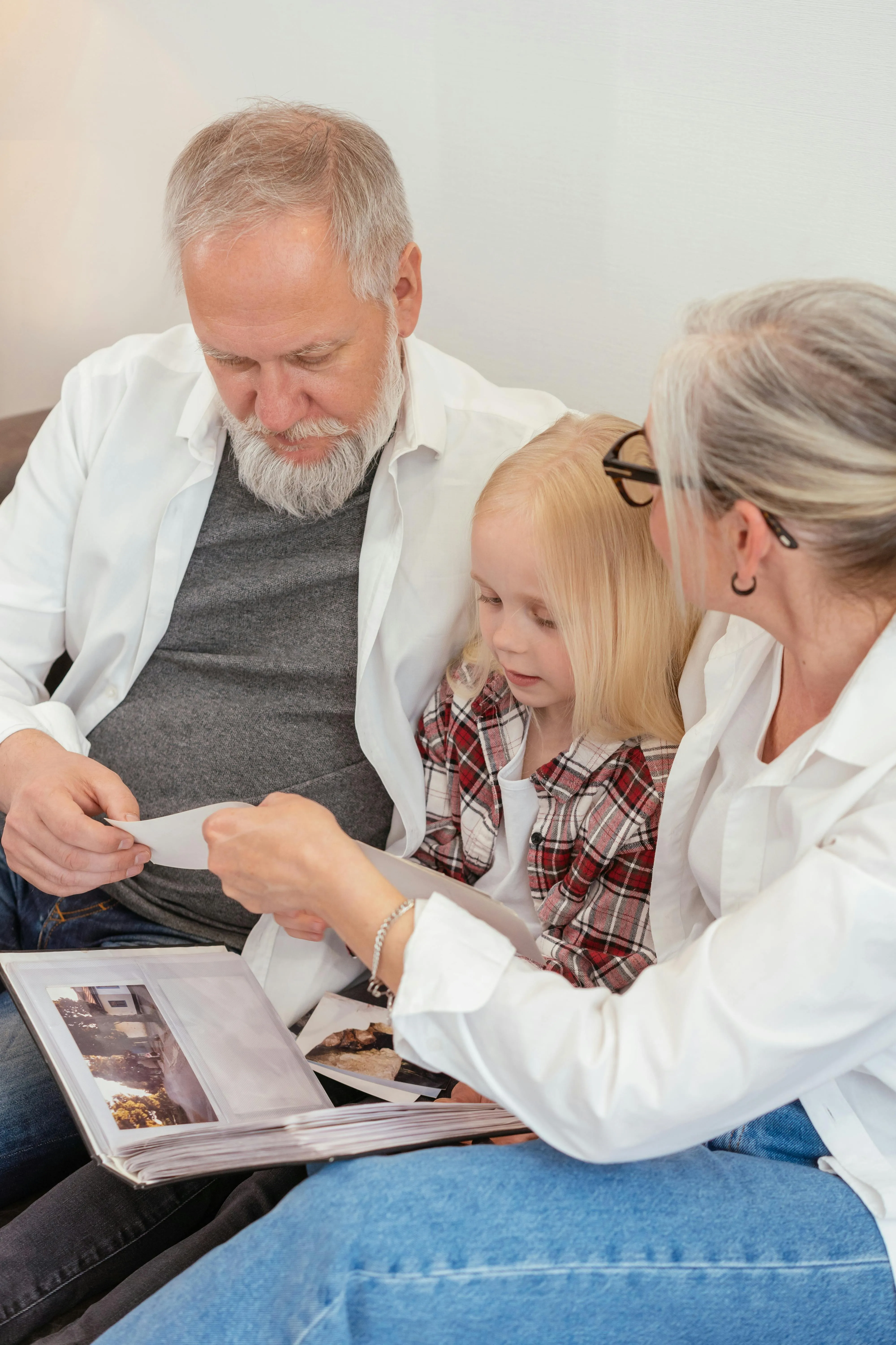 happy elderly couple with grandaughter