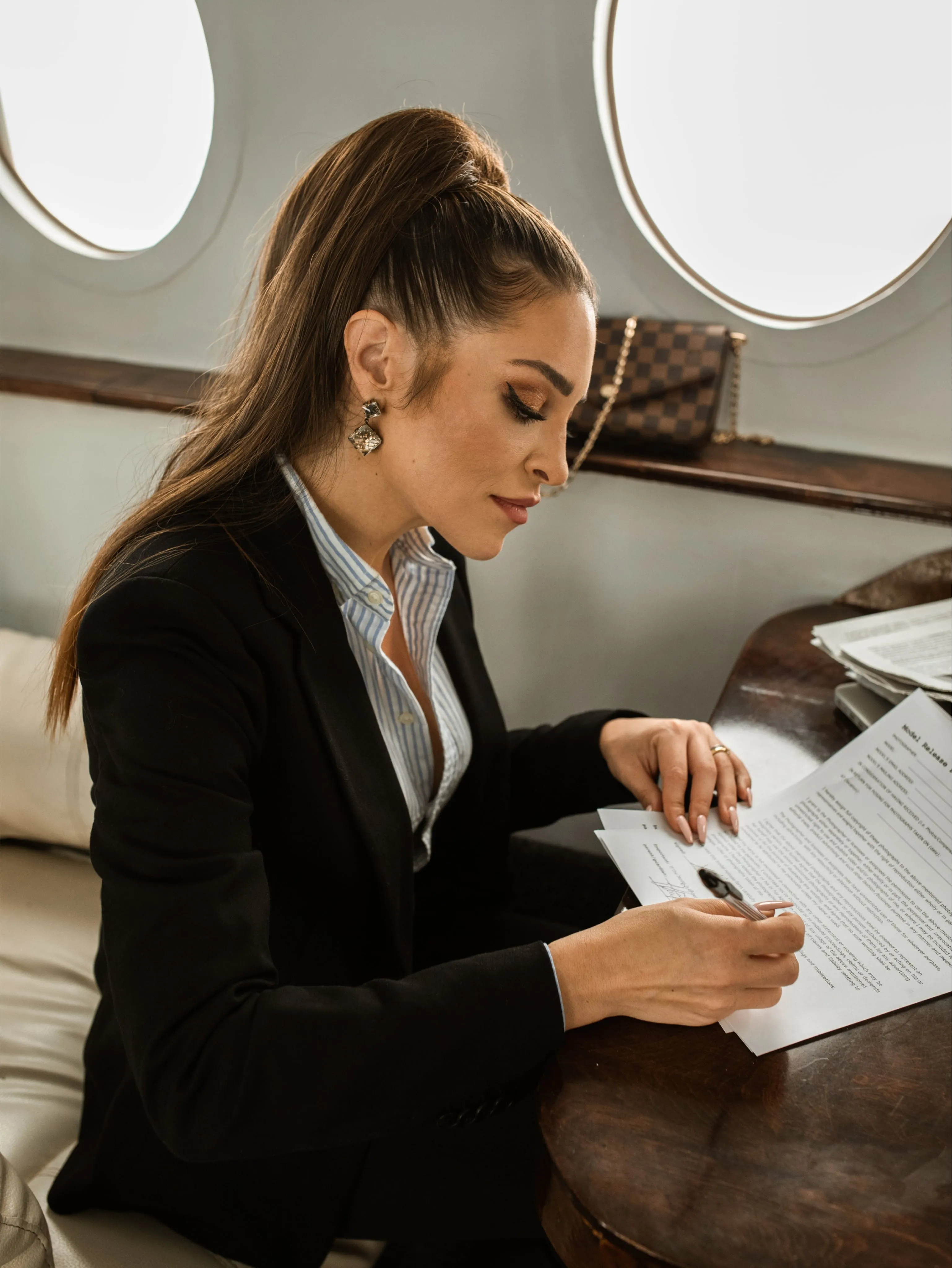 A woman on a jet signing a will